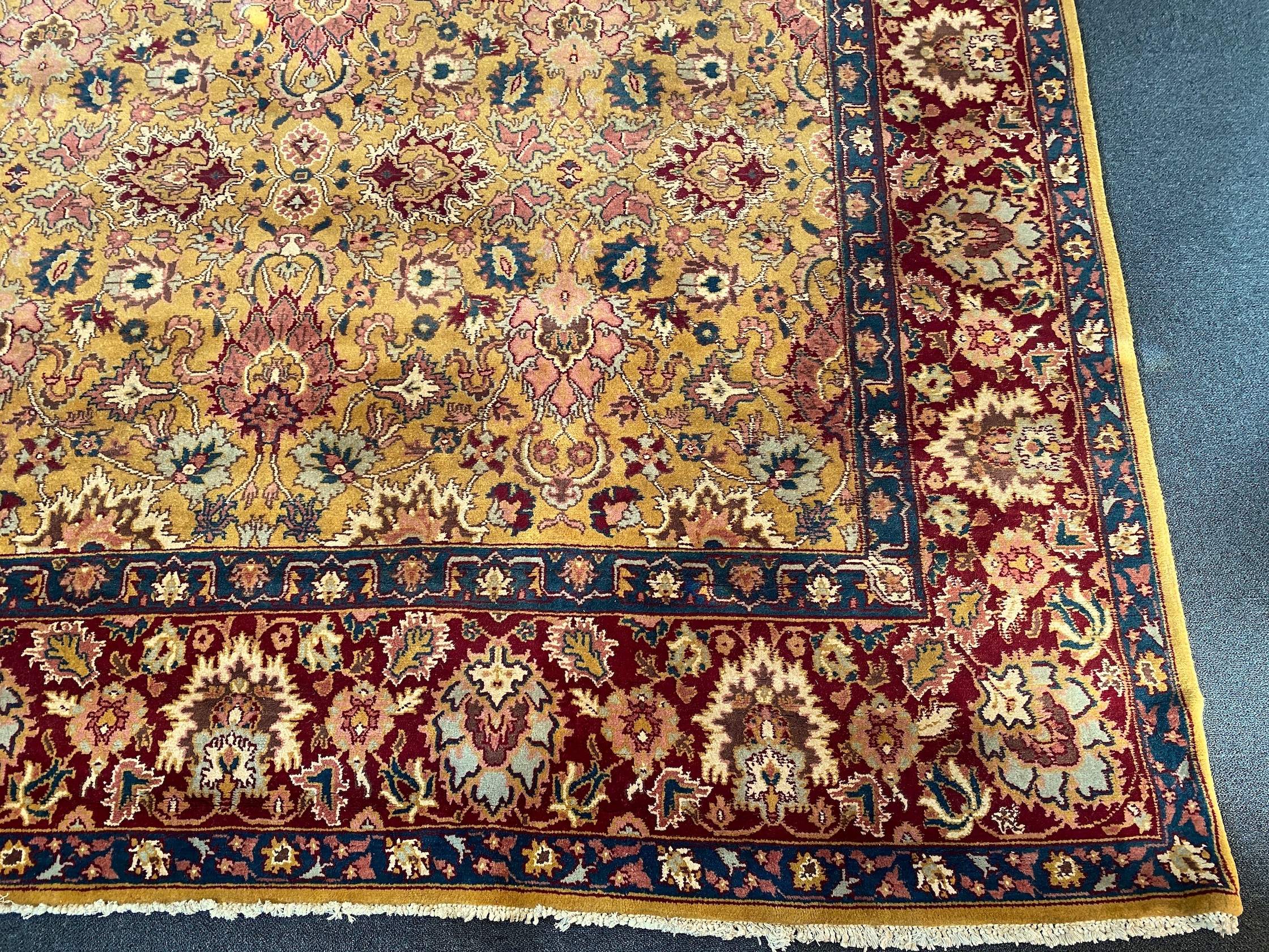 An Agra gold ground carpet with dense palmette field and wide conforming border 360 x 280 cms